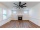 Cozy living room featuring luxury vinyl plank flooring and a stone fireplace at 48 Sanders Farm Dr, Smithfield, NC 27577