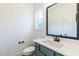 Powder room with vanity, toilet, and mirror at 48 Sanders Farm Dr, Smithfield, NC 27577