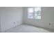 Bright, unfinished room featuring a large window offering neighborhood views, ready for your personal touch and design at 48 Sanders Farm Dr, Smithfield, NC 27577