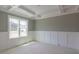 Elegant room with a sophisticated coffered ceiling, wainscoting, and abundant natural light from a large window at 48 Sanders Farm Dr, Smithfield, NC 27577