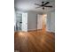 Bedroom with hardwood floors, ceiling fan, and an ensuite bathroom at 4813 Glen Forest Dr, Raleigh, NC 27612