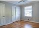 Bedroom featuring wood floors, ceiling fan, closet, and white trim at 4813 Glen Forest Dr, Raleigh, NC 27612