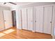 Bedroom featuring wood floors, ceiling fan, closet, and white trim at 4813 Glen Forest Dr, Raleigh, NC 27612