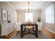 Elegant dining room with modern chandelier, hardwood floors, white buffet and seating for memorable meals at 4813 Glen Forest Dr, Raleigh, NC 27612