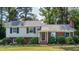 Charming two-story home with blue shutters, brick accents, and well-maintained landscaping at 4813 Glen Forest Dr, Raleigh, NC 27612