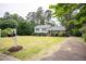 Well-maintained two-story home with a large front yard, mature trees and landscaping at 4813 Glen Forest Dr, Raleigh, NC 27612