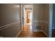 Hallway showcasing hardwood floors and a clear view into the kitchen at 4813 Glen Forest Dr, Raleigh, NC 27612