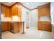 Well-lit kitchen featuring wood cabinets, stainless steel dishwasher, and a countertop breakfast bar at 4813 Glen Forest Dr, Raleigh, NC 27612