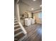 Basement laundry area featuring washer, dryer, wooden storage shelving, and a small window at 4813 Glen Forest Dr, Raleigh, NC 27612