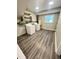 Well-lit laundry room featuring a washer, dryer, and sleek hardwood flooring near a window at 4813 Glen Forest Dr, Raleigh, NC 27612