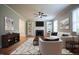 Stylish living room boasting a cozy fireplace, built-in shelves, ceiling fan, and modern furniture arrangement at 4813 Glen Forest Dr, Raleigh, NC 27612