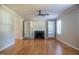 Bright living room features hardwood floors, built-in shelves, and a cozy fireplace at 4813 Glen Forest Dr, Raleigh, NC 27612