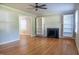 Inviting living room with hardwood floors, ceiling fan, and fireplace with built-in shelving at 4813 Glen Forest Dr, Raleigh, NC 27612