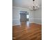 Spacious living room with hardwood floors, open doorway, providing a seamless flow to the dining room at 4813 Glen Forest Dr, Raleigh, NC 27612