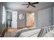 Staged main bedroom with hardwood floors, ceiling fan, and ensuite bathroom at 4813 Glen Forest Dr, Raleigh, NC 27612