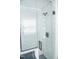 Shower featuring glass door, black hardware, and white subway tile at 4813 Glen Forest Dr, Raleigh, NC 27612