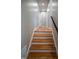 Staircase with hardwood treads and white risers leading to an upper level at 4813 Glen Forest Dr, Raleigh, NC 27612