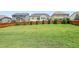 A large, grassy back yard with a wood fence separating neighbors and a beautiful lawn for outdoor activities at 508 Minerva Dale Dr, Fuquay Varina, NC 27526