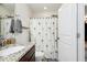 Bathroom featuring granite countertop, tiled floors, and a shower with a palm tree patterned curtain at 508 Minerva Dale Dr, Fuquay Varina, NC 27526