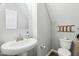 Charming powder room features pedestal sink, hard wood floors, and stylish decor at 508 Minerva Dale Dr, Fuquay Varina, NC 27526