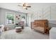 Cozy Bedroom featuring a crib, chair, and large windows for natural light at 508 Minerva Dale Dr, Fuquay Varina, NC 27526