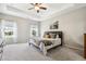 Spacious bedroom with tray ceiling, fan, and ample natural light at 508 Minerva Dale Dr, Fuquay Varina, NC 27526