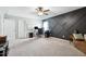 Spacious bonus room with dark accent wall, carpet, and ceiling fan at 508 Minerva Dale Dr, Fuquay Varina, NC 27526