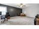 A large bonus room with dark accent wall, carpet, and fan at 508 Minerva Dale Dr, Fuquay Varina, NC 27526