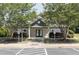 Exterior shot of the clubhouse showing trees, parking, and handicap access at 508 Minerva Dale Dr, Fuquay Varina, NC 27526