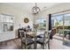 Charming dining area with a modern light fixture, wood table, and sliding glass doors to the outdoor deck at 508 Minerva Dale Dr, Fuquay Varina, NC 27526