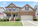 Inviting two-story home featuring a covered front porch, brick facade, and well-maintained landscaping at 508 Minerva Dale Dr, Fuquay Varina, NC 27526
