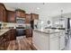 Beautiful kitchen with dark wood cabinets, stainless steel appliances, granite countertops, and a center island at 508 Minerva Dale Dr, Fuquay Varina, NC 27526