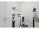 Well-organized laundry room featuring a washer, dryer, storage cabinets, and an ironing board at 508 Minerva Dale Dr, Fuquay Varina, NC 27526