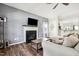 Cozy living room features a fireplace, dark wood floors, and neutral-toned furniture at 508 Minerva Dale Dr, Fuquay Varina, NC 27526