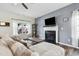 Bright living room with fireplace, ceiling fan, and a large window overlooking the front yard at 508 Minerva Dale Dr, Fuquay Varina, NC 27526
