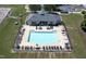 Aerial view of a community pool with lounge chairs and tables surrounded by a black fence at 508 Minerva Dale Dr, Fuquay Varina, NC 27526