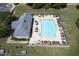 Overhead view of community pool, clubhouse, lounge chairs, and umbrella-covered tables at 508 Minerva Dale Dr, Fuquay Varina, NC 27526