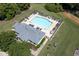 A high angle view features a community pool with lounge chairs and nearby clubhouse at 508 Minerva Dale Dr, Fuquay Varina, NC 27526