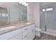Bright bathroom featuring granite countertops, double sinks and sleek tile shower at 509 Sherron Rd # 30, Durham, NC 27703