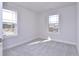Bedroom featuring neutral carpet, white trim and bright light from the double windows at 509 Sherron Rd # 30, Durham, NC 27703