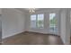 Sun-lit dining room with a chandelier, wood floors, and access to outdoor balcony at 509 Sherron Rd # 30, Durham, NC 27703