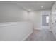 Upstairs hallway leading to bedrooms featuring neutral carpet and crisp, white trim at 509 Sherron Rd # 30, Durham, NC 27703