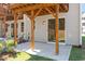 Backyard patio features wooden support beams, bright green grass and private wooded views at 509 Sherron Rd # 30, Durham, NC 27703