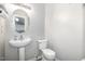 Half bathroom with a pedestal sink, and a modern toilet at 5416 Kissimmee Ln, Raleigh, NC 27616