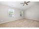 A bedroom with a ceiling fan, two windows, and wall-to-wall carpeting at 5416 Kissimmee Ln, Raleigh, NC 27616