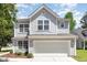 Charming two-story home featuring gray siding, a spacious two-car garage, and well-maintained landscaping at 5416 Kissimmee Ln, Raleigh, NC 27616