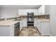Functional kitchen with white cabinets, stainless steel appliances, and modern tile flooring at 5416 Kissimmee Ln, Raleigh, NC 27616