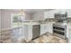 Well-lit kitchen featuring white cabinets, stainless steel appliances, and stylish backsplash at 5416 Kissimmee Ln, Raleigh, NC 27616