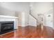 Bright living room with a fireplace, hardwood floors, and open floor plan at 5416 Kissimmee Ln, Raleigh, NC 27616