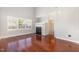 Bright living room featuring hardwood floors, large window and fireplace at 5416 Kissimmee Ln, Raleigh, NC 27616